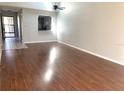 Spacious living room with wood-look floors and high ceilings at 5429 Vineland Rd # S, Orlando, FL 32811