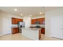 Modern kitchen with stainless steel appliances and granite countertops at 5650 Wooden Pine Dr, Orlando, FL 32829