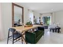 Open concept dining area with a wooden table and green bench seating at 6034 Galloping Dr, Apopka, FL 32712