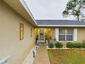 House entrance with walkway, landscaping, and a decorative door at 6928 Sw 152Nd St, Ocala, FL 34473