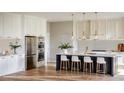 Bright kitchen with white cabinets, stainless steel appliances, a navy island, and chic pendant lighting at 1830 Park Lake St, Orlando, FL 32803
