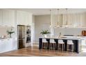 Gourmet kitchen boasts stainless steel appliances, white cabinetry, and a large island with seating at 1830 Park Lake St, Orlando, FL 32803