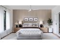 Bright main bedroom with wood-paneled walls, a plush bed, and plenty of natural light at 1830 Park Lake St, Orlando, FL 32803