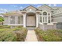 Front entry with double doors and decorative columns at 2225 Kettle Dr, Orlando, FL 32835