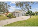 View of the home's rear exterior featuring an attached garage and basketball hoop at 2225 Kettle Dr, Orlando, FL 32835