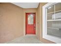 Red front door with a glass panel and a white frame at 2267 Santa Lucia St, Kissimmee, FL 34743