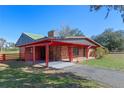 Brick ranch home with covered porch and metal roof at 274 W Kings Hwy, Center Hill, FL 33514