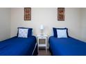 Cozy bedroom with twin-size beds, nightstands and wall art at 3045 Beach Palm Ave, Kissimmee, FL 34747