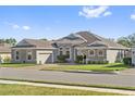House exterior showcasing a two-car garage and landscaping at 310 Lake Mariana Pl, Auburndale, FL 33823