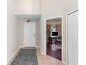 Bright entryway with tile flooring, a view of an office, and a rug at 3233 Egrets Landing Dr, Lake Mary, FL 32746