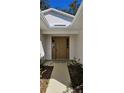 House entrance with brown door, walkway, and landscaping at 32712 Timberwood Dr, Leesburg, FL 34748