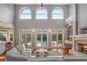 Spacious living room with fireplace, high ceilings, and access to pool at 3413 Lilas Ct, Windermere, FL 34786