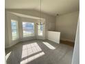 Bright dining area with large windows and a stylish chandelier at 4486 Segafield, St Cloud, FL 34773