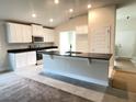 Modern kitchen featuring white cabinets, granite countertops, and stainless steel appliances at 4486 Segafield, St Cloud, FL 34773