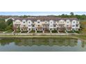 Aerial view of townhouses near a lake at 585 Piazza Pt, Oviedo, FL 32765