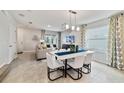 Bright dining room with modern light fixture and seating for six at 676 Kimber Ln # 37, Debary, FL 32713