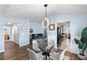 Glass dining table with chairs and an open view to the living room at 8321 Bella Vida Cir # 8321, Davenport, FL 33896