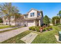 Two-story townhome with a two-car garage and well-manicured landscaping at 8321 Bella Vida Cir # 8321, Davenport, FL 33896