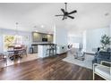 Open floor plan with hardwood floors, kitchen island, and comfortable seating at 8321 Bella Vida Cir # 8321, Davenport, FL 33896