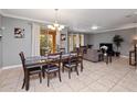 Elegant dining area with dark wood table and access to backyard at 8876 Candy Palm Rd, Kissimmee, FL 34747