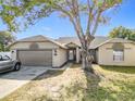 Single-Gathering home with a two-car garage and mature tree at 933 El Lago Ter, Winter Springs, FL 32708