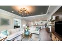 Spacious living room with an open floor plan and a large TV at 1212 Teal Creek Dr, St Cloud, FL 34769
