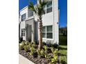 Modern two-story house with palm tree and manicured landscaping at 1453 Serendipity Ln, Clermont, FL 34714