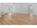 Open living space with light wood flooring, access to front entrance at 15410 Sw 23Rd Court R, Ocala, FL 34473