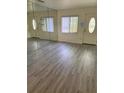 Spacious living room featuring gray vinyl plank flooring and large mirror at 1801 Hage Way, Orlando, FL 32805