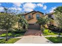 Two-story house with a brown garage door and brick driveway at 1913 Nice Ct, Kissimmee, FL 34747