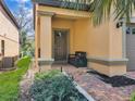 Front entrance with a dark brown door and brick walkway at 1913 Nice Ct, Kissimmee, FL 34747