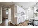 White kitchen features stainless steel appliances and wood flooring at 1913 Nw 12Th St, Ocala, FL 34475