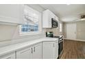 Modern white kitchen with stainless steel appliances and quartz countertops at 1913 Nw 12Th St, Ocala, FL 34475
