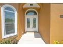 Inviting front entrance featuring double glass doors and an arched transom window allowing natural light at 1943 Sipes Ave, Sanford, FL 32771