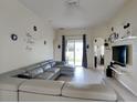Living room with sectional sofa, sliding glass doors, and a view of backyard at 2739 Star Grass Cir, Kissimmee, FL 34746