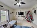 Living room with sectional sofa, Christmas tree, and large window at 2739 Star Grass Cir, Kissimmee, FL 34746