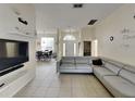 Spacious living room featuring a large sectional sofa and flat-screen TV at 2739 Star Grass Cir, Kissimmee, FL 34746