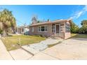 Front view of a charming tan house with a unique tiled walkway at 421 Jefferson St, Daytona Beach, FL 32114