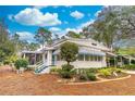 Well-maintained home featuring a screened porch, manicured landscaping, and an inviting front entrance at 598 E Club Blvd, Lake Mary, FL 32746