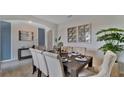 Elegant dining room with a dark wood table and neutral chairs at 1218 Limbali St, Mount Dora, FL 32757