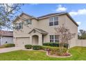 Two-story house with landscaping and a green door at 14031 Willow Grace, Orlando, FL 32824