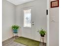 Bright and airy entryway with wood-look flooring and potted plants at 1643 Wynford Cir, Tavares, FL 32778