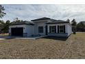 New construction home with gray and white exterior and a two-car garage at 16674 Sw 25Th Ct, Ocala, FL 34473