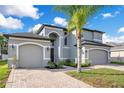 Two story house with gray siding, three car garage, and landscaping at 1763 Stargazer Ter, Sanford, FL 32771