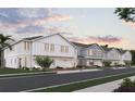 Row of townhomes with gray and white siding and two-car garages at 205 Glass Onion Dr, Howey In The Hills, FL 34737