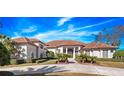 Stunning two-story home with tile roof, lush landscaping, and circular driveway at 2224 Alaqua Dr, Longwood, FL 32779