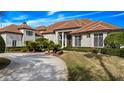 Grand two-story home with a tile roof and manicured landscaping at 2224 Alaqua Dr, Longwood, FL 32779