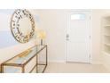 Bright entryway with a gold mirror, console table, and built-in shelving at 2432 Dubai St, Kissimmee, FL 34747