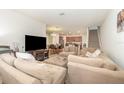 Spacious living room featuring a large sectional sofa and flat-screen TV at 250 Merry Brook Cir, Sanford, FL 32771