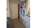 Bright entryway with tile floor and art at 2624 Robert Trent Jones Dr # 615, Orlando, FL 32835